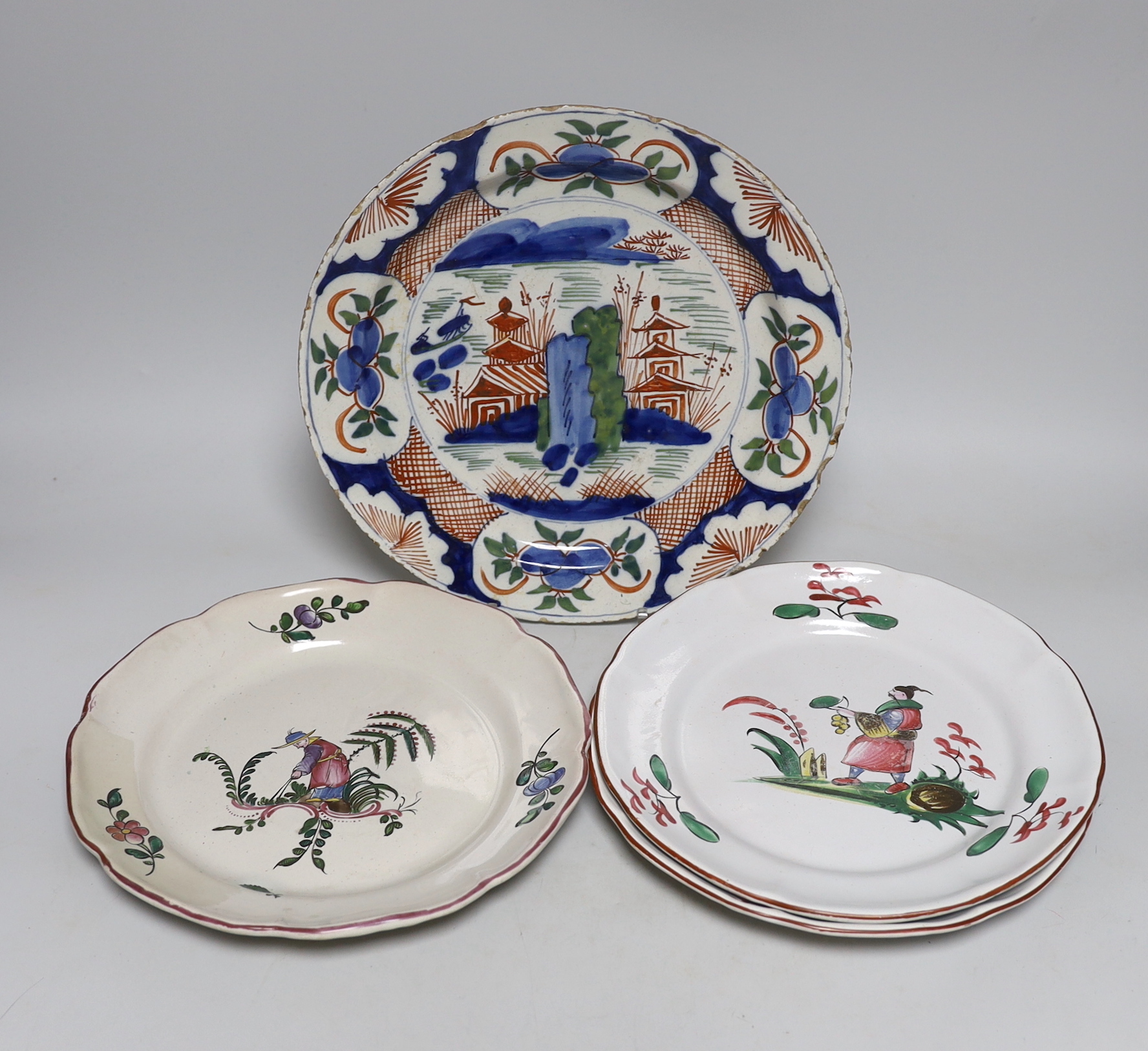 An 18th century Delft plate and three 19th century faience plates, largest 26cm diameter (4)